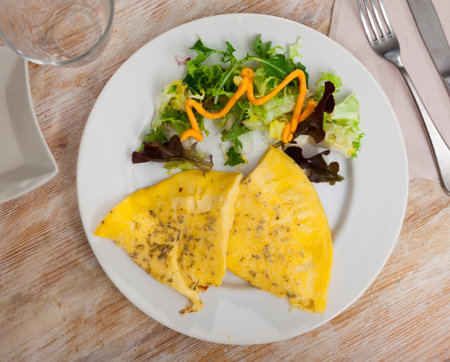 Omelet and arugula on a white plate. Delicious breakfastの写真素材