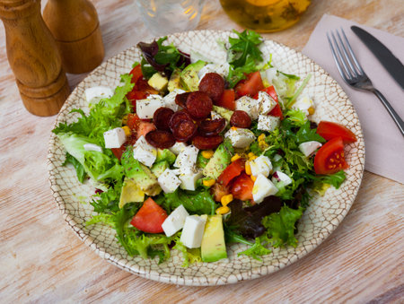 Catalonian salad with sausages, avocado and cheeseの写真素材