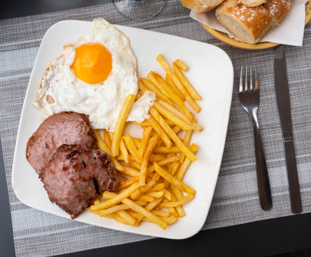 Roasted meat cutlet with potato and eggsの写真素材