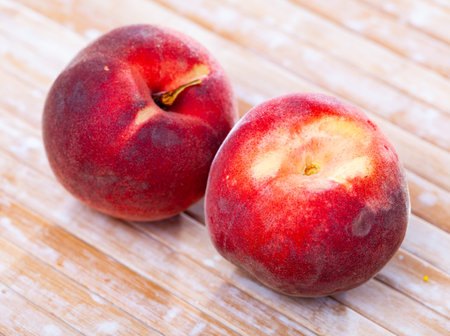 Juicy ripe peaches on wooden tableの写真素材