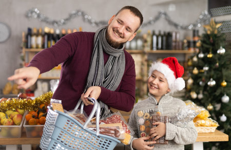 Man and his son choose snacks and productsの写真素材