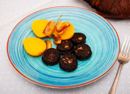 Blood sausages served with potato and onionの写真素材
