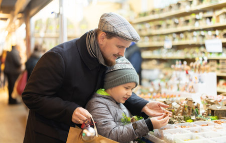 Father and son choose figures for the nativity sceneの写真素材