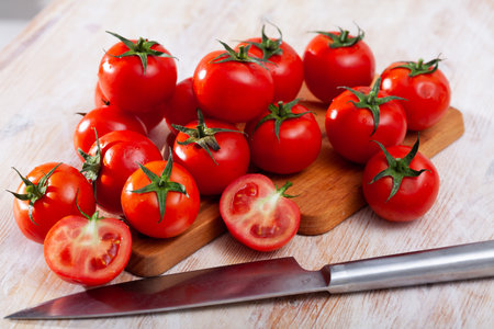 Whole and cut in half ripe tomatoesの写真素材