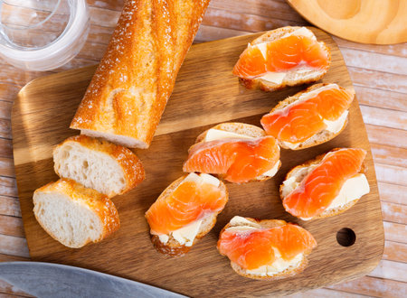 Sandwiches with butter and salted salmon on wooden boardの写真素材
