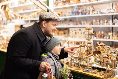 Father and son choosing figurines at the fairの写真素材