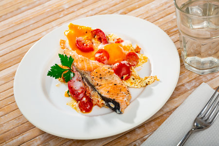 Fried eggs with salmon and cherry tomatoの写真素材