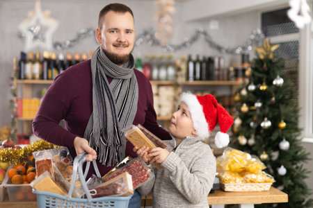 Father and son shopping for holiday celebration in festive marketの写真素材