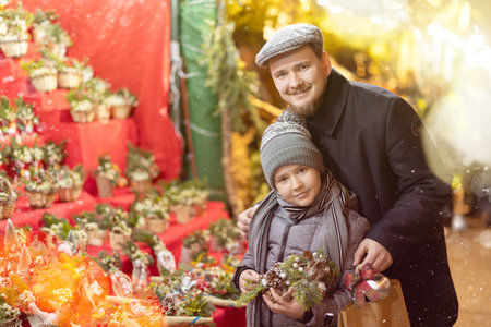 During Christmas fair, father and son choose composition, bouquet of fir branches, eucalyptus shootsの写真素材