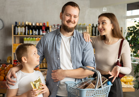 Friendly family shopping for groceries in supermarketの写真素材