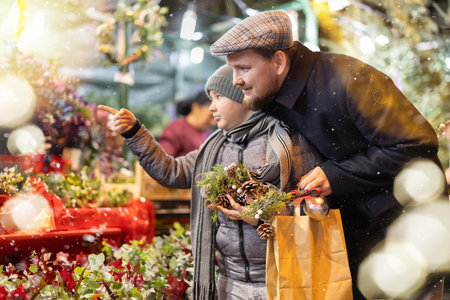 Man and his son choose plant branches for decorationの写真素材