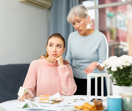 Senior woman and her daughter having financial troubles