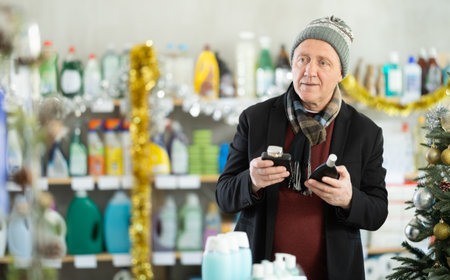 Elderly man choosing perfume for Christmasの写真素材