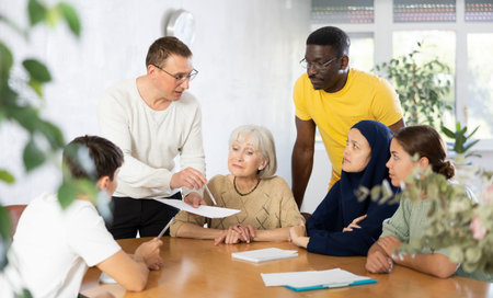 Men and women different ages discussion during business course in classroom