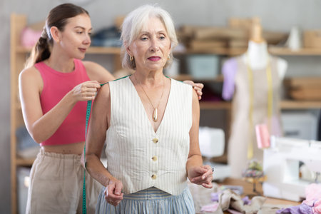 Woman measures senior female client