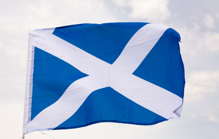 Large flag of Scotland waving against skyの写真素材