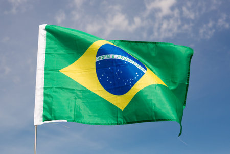 Brazil flag waving against blue sky