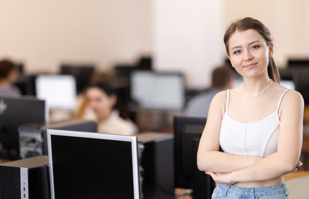 Portrait of a successful young female student in university computer class
