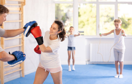 Man and woman training boxing in studio