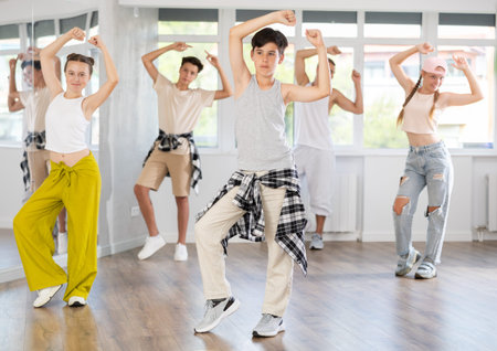 Teenage boy dancing hip hop in group