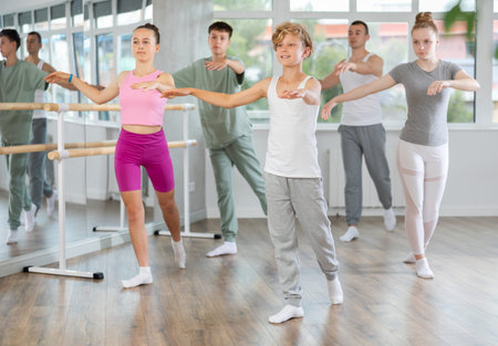 Teenage boy practicing ballet positions in dance studio