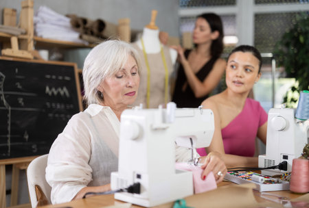 Mature and middle-aged women working with sewing machine