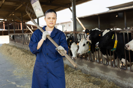 Asian woman farmer with pitchforks on farmの写真素材
