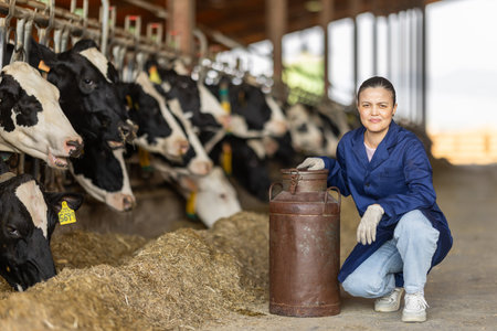 Asian woman employee with metal milk canの写真素材