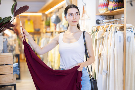 Woman choosing a dress in a clothing store
