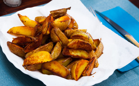Tasty cooked baked in oven salted potatoes served at plateの写真素材