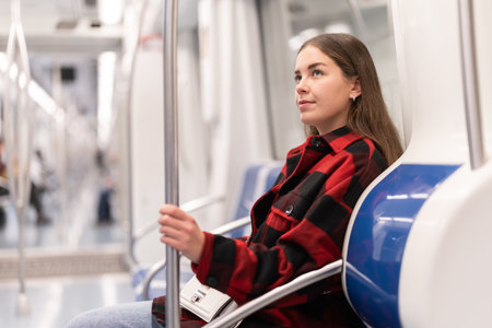Girl sit in tram car, getting to workの写真素材