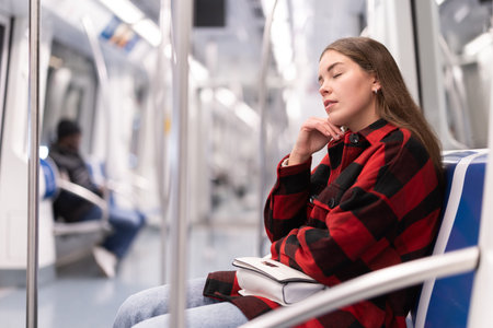 Girl sit and doze in tram car, getting to work