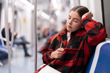 Tired woman returns to the subwayの写真素材