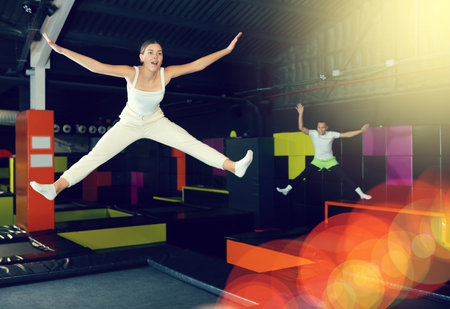 Woman sportswoman fitness jumping on club trampolineの写真素材