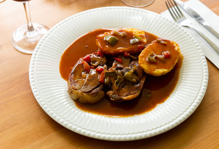 Oven baked lamb with potato and sauceの写真素材