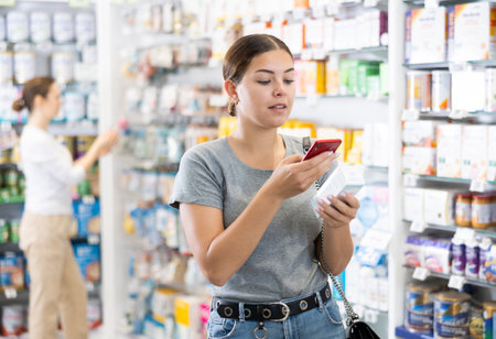 Young woman looking for remedy from photo on internetの写真素材