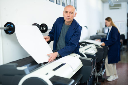 Man using printer while working in print shop