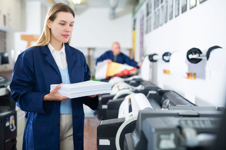 Woman loading ream of paper into printer