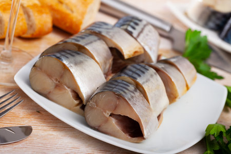 Lightly salted mackerel cut into pieces with parsley on tableの写真素材