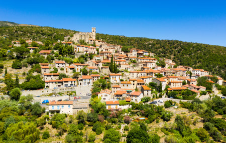 Aerial view of Eus village on hill with ancient church, Franceの写真素材