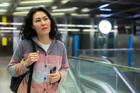 Woman traveler at hall of subway station