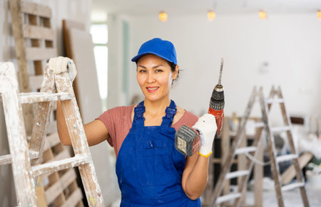 Portrait of asian woman builder with drill