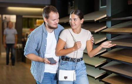 Couple man and woman choosing laminate sampleの写真素材