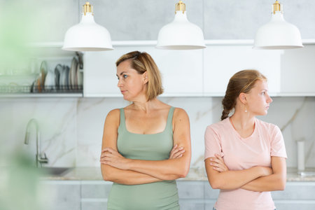 Mum and daughter do not talk and look in different directions.
