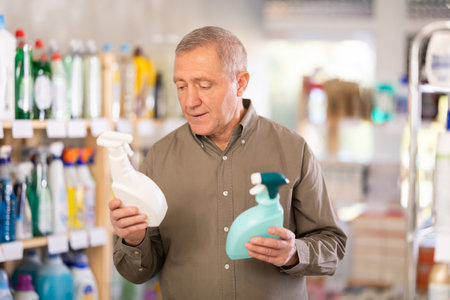 European man choosing spray in supermarketの写真素材