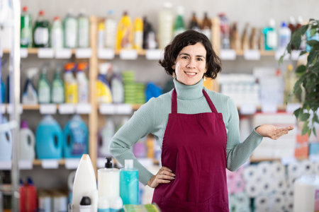 Middle-aged saleswoman welcoming clients in retail store