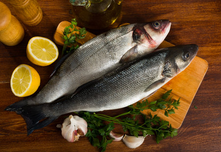Uncooked sea bass fish with lemon