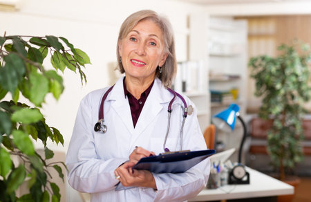 Woman doctor standing at clinic officeの写真素材
