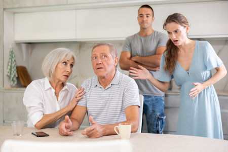 Family quarrel - couple is unhappy with elderly parents, express dissatisfactionの写真素材