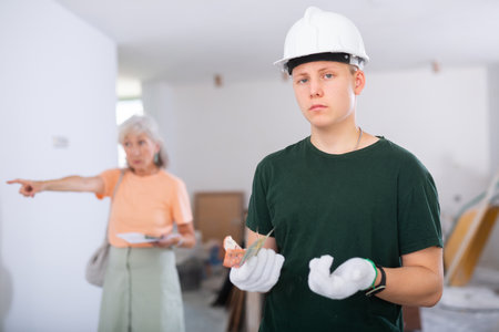 The man is dissatisfied with the money earned for his first job as a house painter.の写真素材